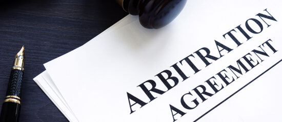 Arbitration agreement and gavel on a desk.