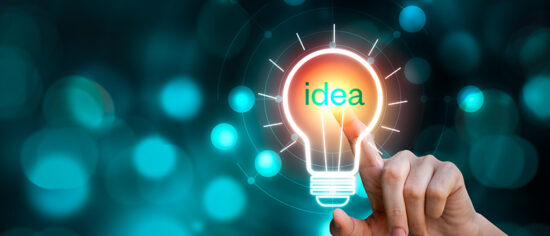 Hand touching the light bulb sign with idea text on blurred background. Creative innovation